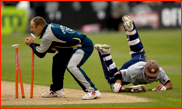 Mark Butcher makes his ground past James Tredwell