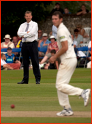 Stand-in umpire Tim Tremlett watches his son Chris bowl