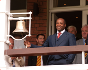 Brian Lara rings the 'five minute' bell outside the Bowler's Bar, 2012