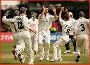 Bowler Jon Lewis celebrates the wicket of Ben Smith