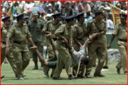 A spectator is carried off by police, Dambulla, Sri Lanka.