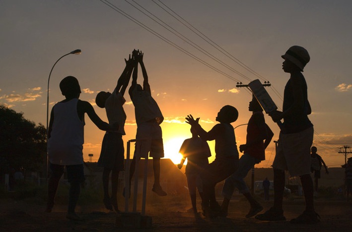 Township children playing cricket.