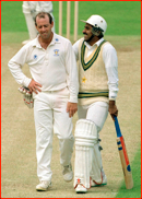 Bowler Simon Hughes makes Javed Miandad laugh