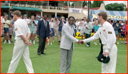 England captain Michael Atherton walks away from President Mugabe.